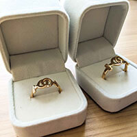 Custom female-female wedding bands in fancy jewelry boxes