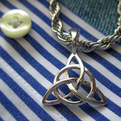 Custom Sterling silver triquetra pendant on a blue and white striped shirt